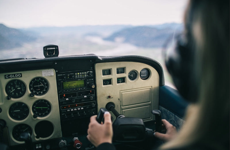 photo of cockpit and a pilot’s hands